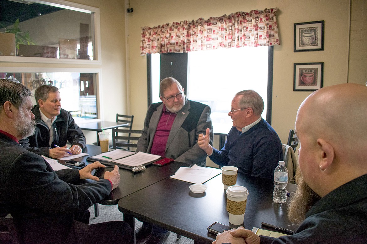 Sen. Steve Daines met with community members Saturday at Hav-A-Java to discuss concerns over the Libby Superfund clean-up. During the discussion, George Jamison told Daines that concerns over future owner liability for asbestos cleanup went beyond homes, and included other buildings as well. Foreground: Montana Rep. Steve Gunderson and Libby City Council Member Gary Beach; Background: Daines, Lincoln County Commissioner Mark Peck and Jamison. (Ben Kibbey/The Western News)