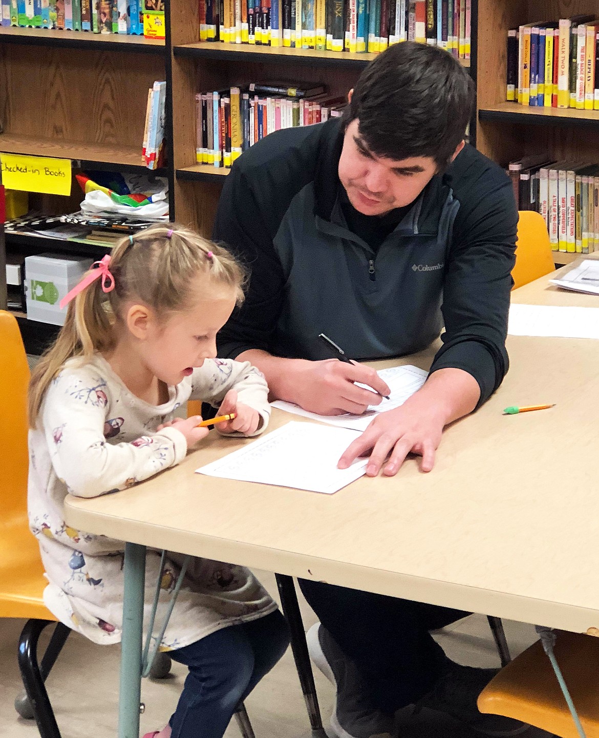 Kaylee shows teacher Cameron Barber how she can identify numbers. (Erin Jusseaume/ Clark Fork Valley Press)