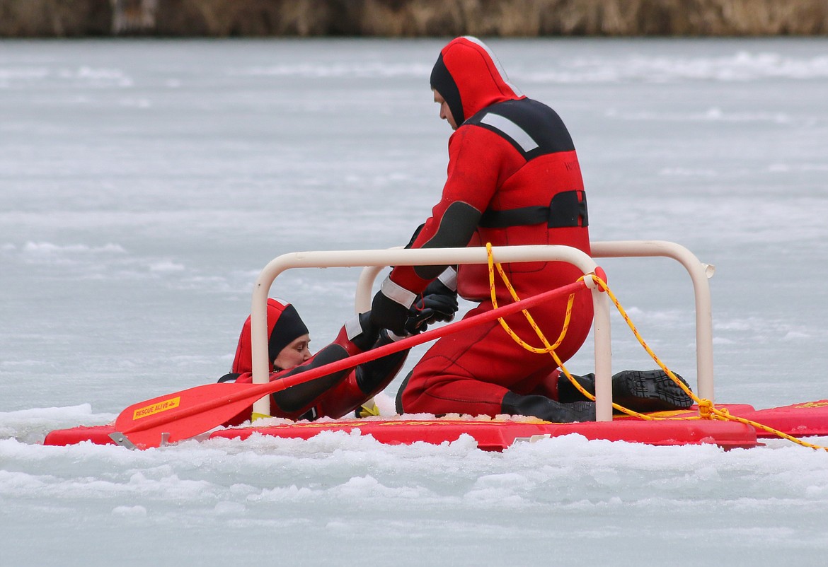 Photo by MANDI BATEMAN
Hall Mountain Firefighters, Marty and Sandy Steinhagen, practice pulling a victim from the frozen water.