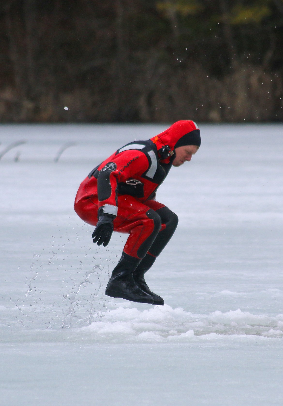 Photo by MANDI BATEMAN
Hall Mountain Volunteer Firefighter Ben Allinger attemps to find rotten ice by jumping on it during ice rescue training.