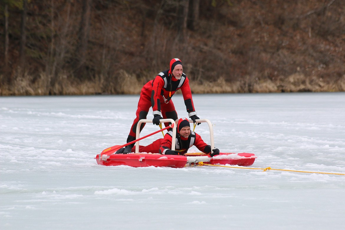 Photo by MANDI BATEMAN
Hall Mountain Volunteer Firefighters Andy Durette and Marty Steinhagen practice with the ice sled.