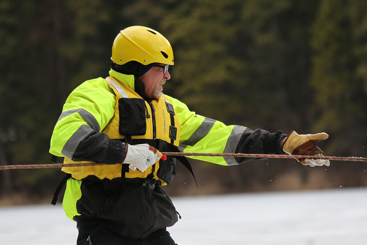 Photo by MANDI BATEMAN
Hall Mountain Volunteer Firefighter Dave Adams works to pull the sled across the ice.