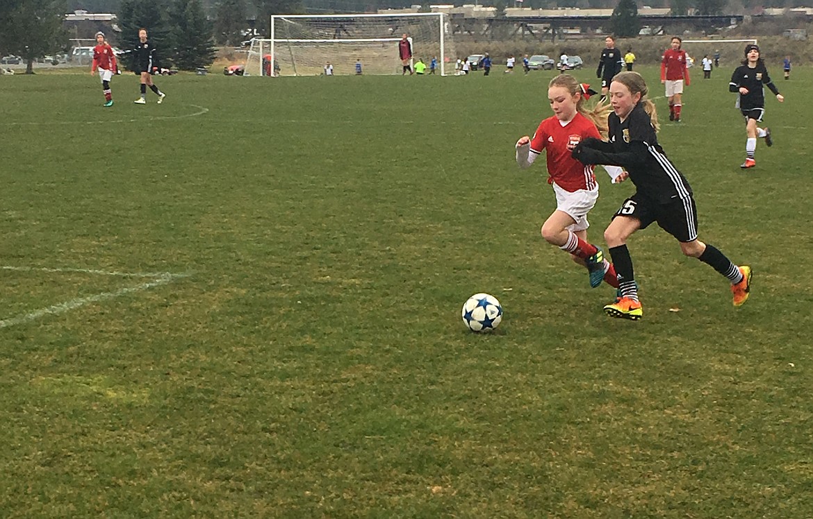 Courtesy photo
Paige Hunt, left, of the Sting Timbers &#146;07 girls soccer team battles an opposing player for the ball in a recent game.