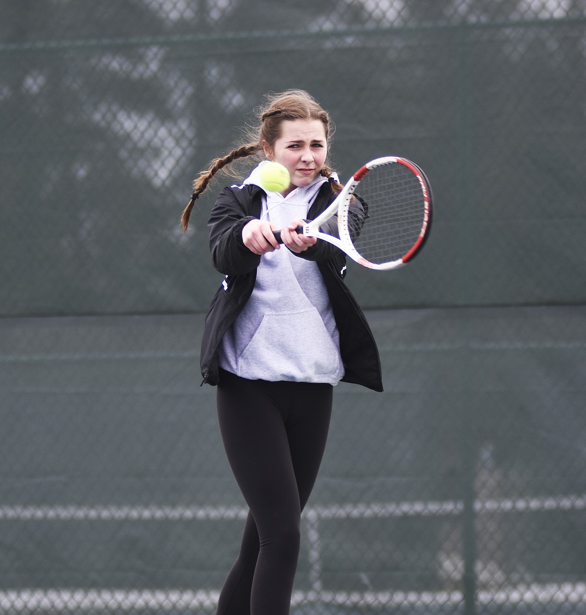 Claire Carloss returns a Columbia Falls serve last Tuesday at Flathead Valley Community College.