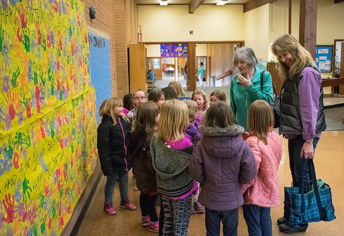 Ray Eanes signs “thank you” to children at Libby Elementary School as they wish her a happy 80th birthday on April 12. Eanes has been teaching sign language to kindergarten and first grade students at Libby Elementary School for about 23 years, and teachers and students put their around 600 handprints on posters as part of a celebration to thank her for her volunteer service. (Ben Kibbey/The Western News)