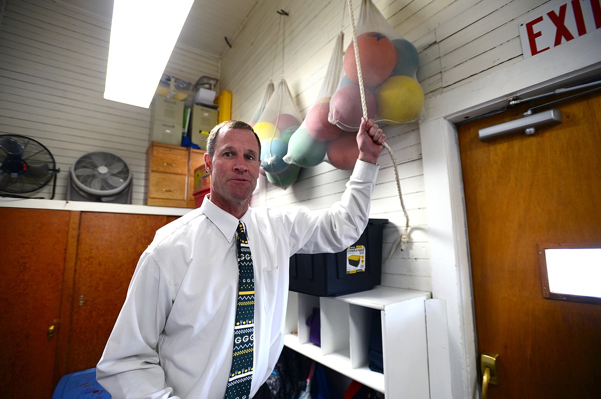 Dan Block, principal at Deer Park School, tugs the rope connected to the bell on top of the schoolhouse on Thursday, April 5. (Casey Kreider/Daily Inter Lake)