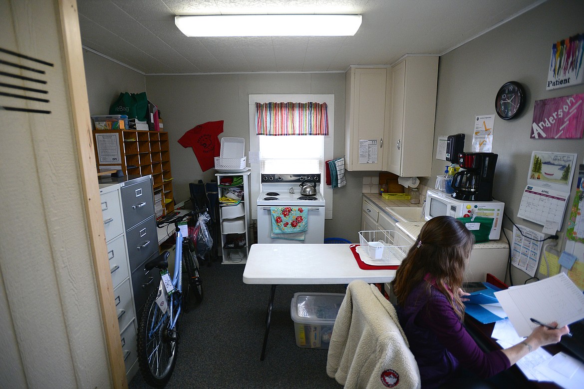 Tana Anderson, office assistant and lunch coordinator, at her desk in the school office area at Deer Park School on Thursday, April 5. (Casey Kreider/Daily Inter Lake)