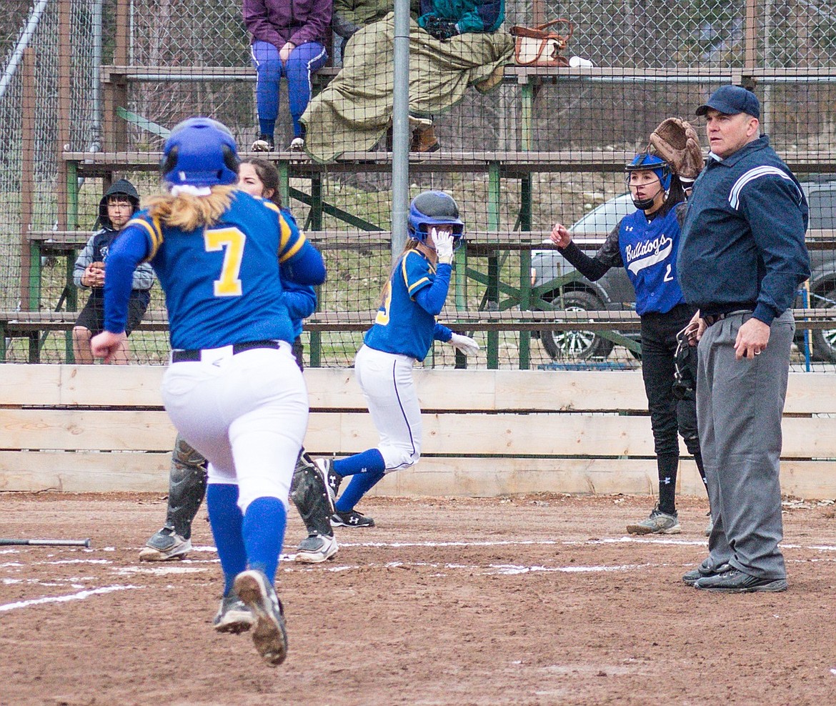 Libby senior Khalyn Hageness follows junior Linsey Walker in to home after a double by junior Jayden Winslow during the Lady Loggers&#146; 15-3 win over Mission on April 6. (Ben Kibbey/The Western News)