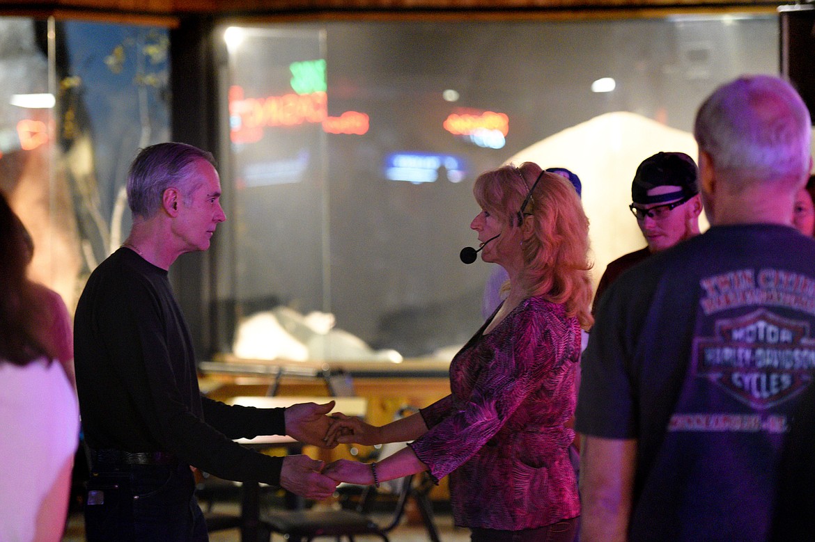 Dance teacher April Howard demonstrates a step with Sam Lageose, of Kalispell, at the Blue Moon Nite Club in Columbia Falls on Wednesday, March 28. (Casey Kreider/Daily Inter Lake)