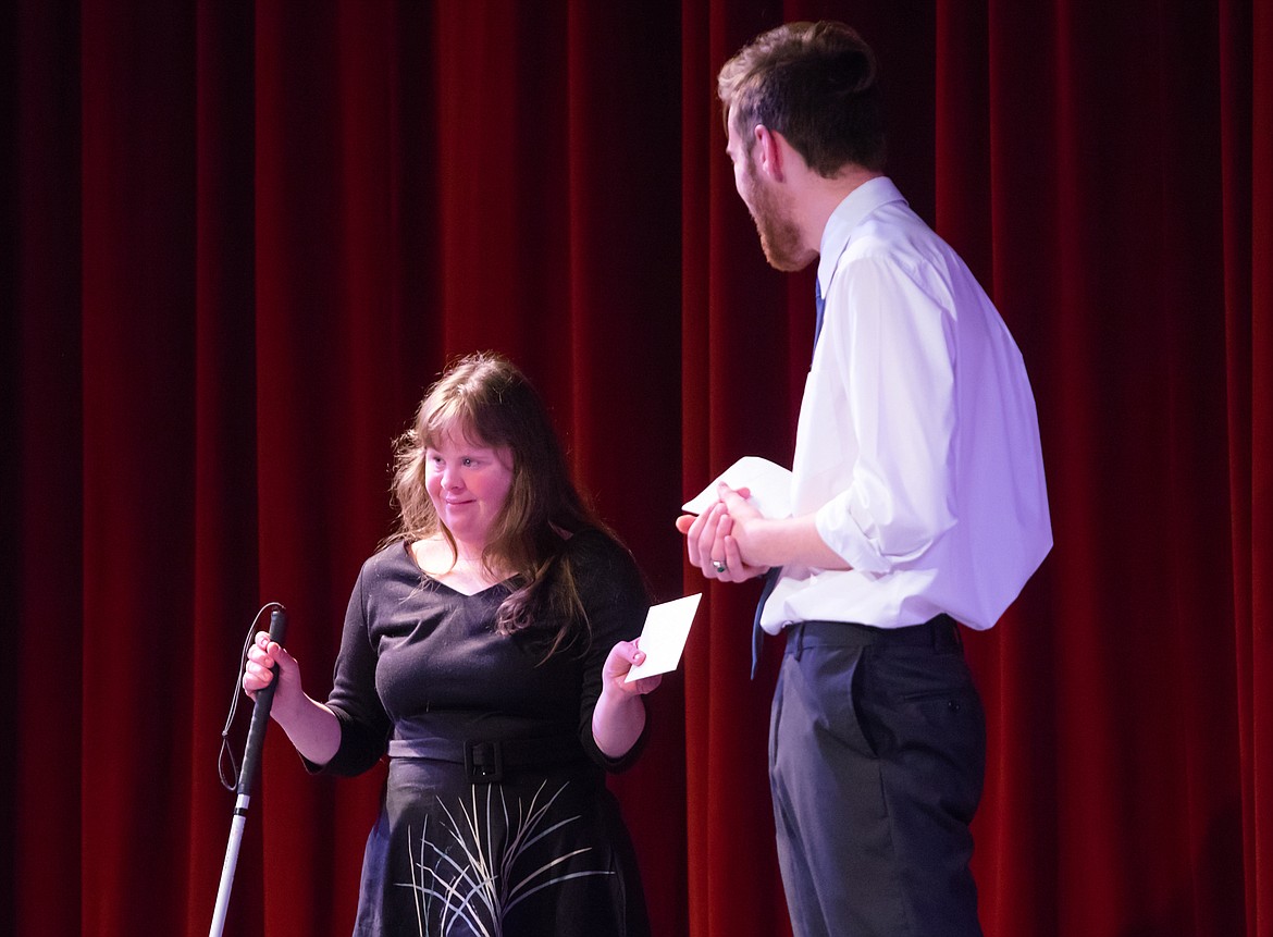 Abi Kurtz accepts the Audience Choice award from host Ethan Mercer following the talent show.