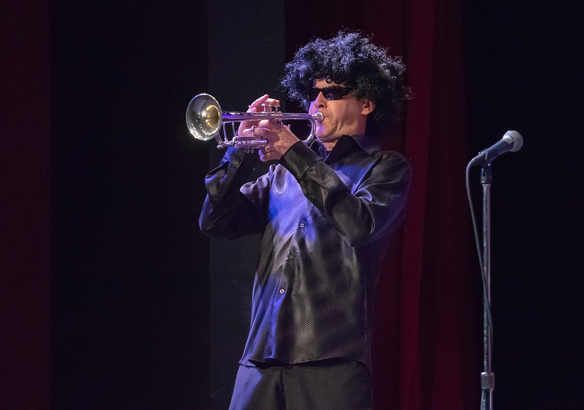 A wig-wearing Mark McCrady blasts a trumpet solo during the talent show.