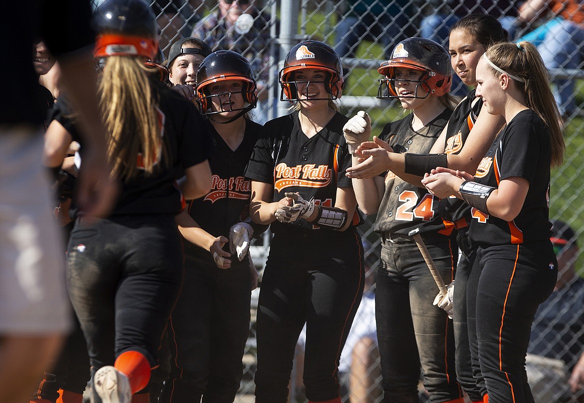 Teammates greet Post Falls&#146; Bailey Gleaves at home plate to celebrate her home run against Lake City.  (LOREN BENOIT/Press)
