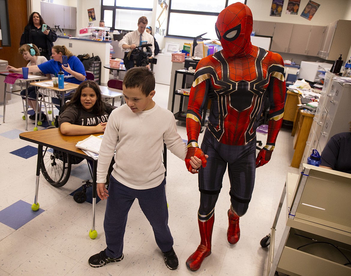 Park Williams, a River City Middle School seventh-grader with Down syndrome, escorts Spider-Man to greet his classmates. (LOREN BENOIT/Press)