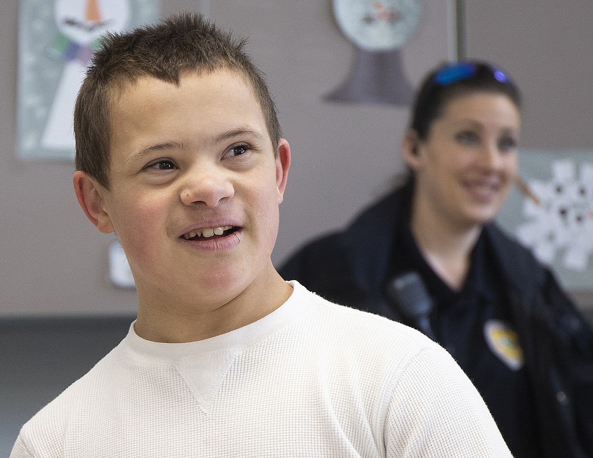 Park Williams, a River City Middle School seventh-grader with Down syndrome, reacts to seeing Spider-Man, one of his heroes, Friday morning at school.