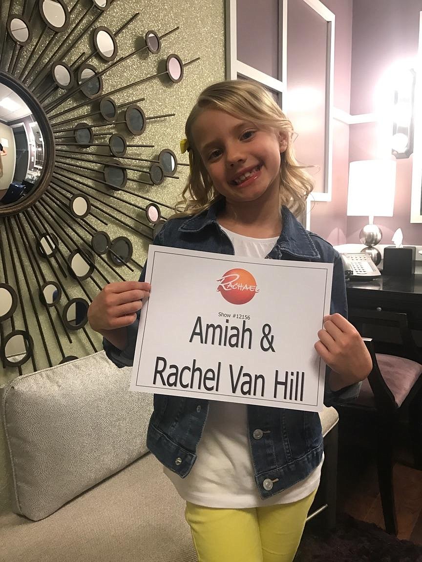 Hayden Meadows second-grader Amiah Van Hill holds up a sign with her and her mom's names as she prepares to go on the &quot;Rachael Ray Show,&quot; which taped in New York City on April 19. Amiah is determined to raise $100,000 to erase school lunch debt in Idaho through her work with her nonprofit, Lemonade 4 Lunch. She will appear with her mom, Rachel, on today's &quot;Rachael Ray&quot; at 3 p.m. PST on KXLY. (Courtesy photo)