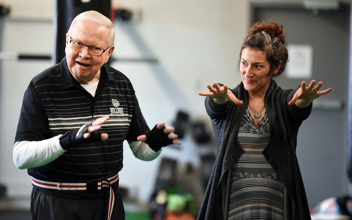 Volunteer Loretta Merriman, right, keeps close watch as boxer Norm Hagen takes part in a warmup exercise during the RockSteady Boxing for Parkinson&#146;s class on Wednesday morning, April 25, at Access Fitness in Kalispell.
(Brenda Ahearn/Daily Inter Lake)