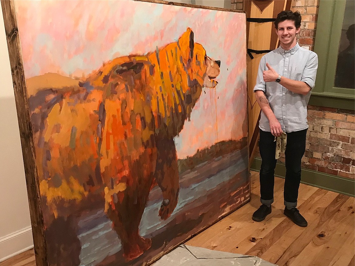Mason Miles, curator of The Art Spirit Gallery, stands near a painting by Jeff Weir. (Courtesy photo)