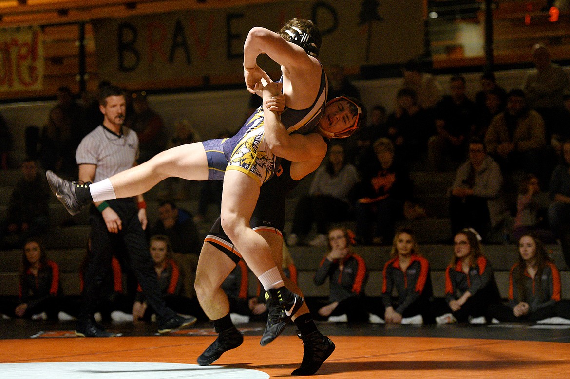 Flathead&#146;s Tucker Nadeau lifts Missoula Big Sky&#146;s Tommy Leonard at 205 pounds at Flathead High School on Thursday. Nadeau won by pin. (Casey Kreider/Daily Inter Lake)