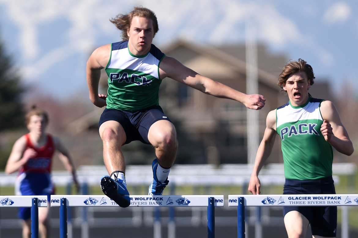 Glacier&#146;s Preston Blain, left, and Jake Smith, right, compete in the boys 300 meter hurdles during the Glacier Cinco track meet at Glacier High School on Thursday. (Casey Kreider/Daily Inter Lake)