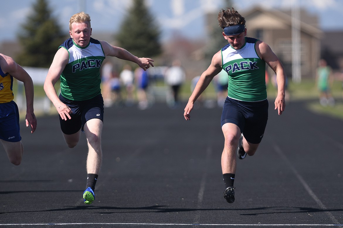 Glacier&#146;s Adam Bartlett, left, and Danny Anderson lean in at the finish of the boys 100 meter dash during the Glacier Cinco track meet at Glacier High School on Thursday. (Casey Kreider/Daily Inter Lake)