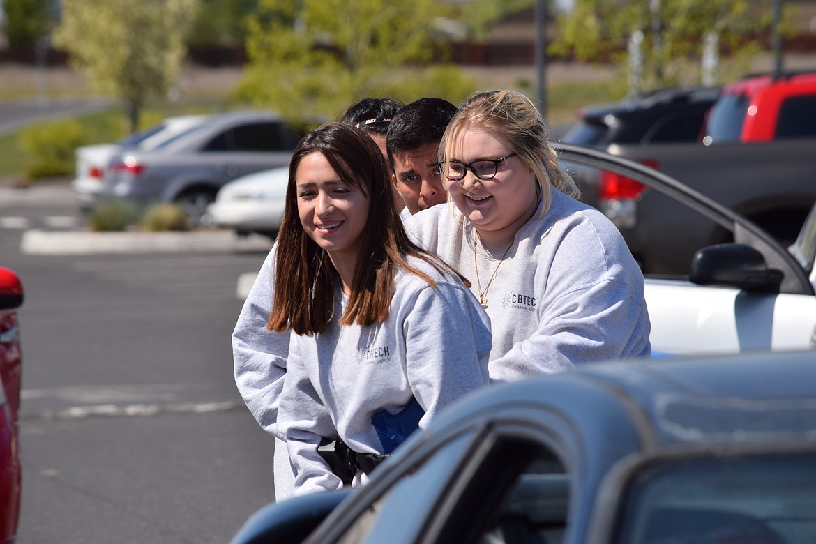 Charles H. Featherstone/Columbia Basin Herald
Four CB Tech law enforcement and criminal justice students, led by Kaylee Castilleja and Samantha Petersen, advance on a &#145;suspect car&#146; in the CB Tech parking as part of class training on Wednesday.