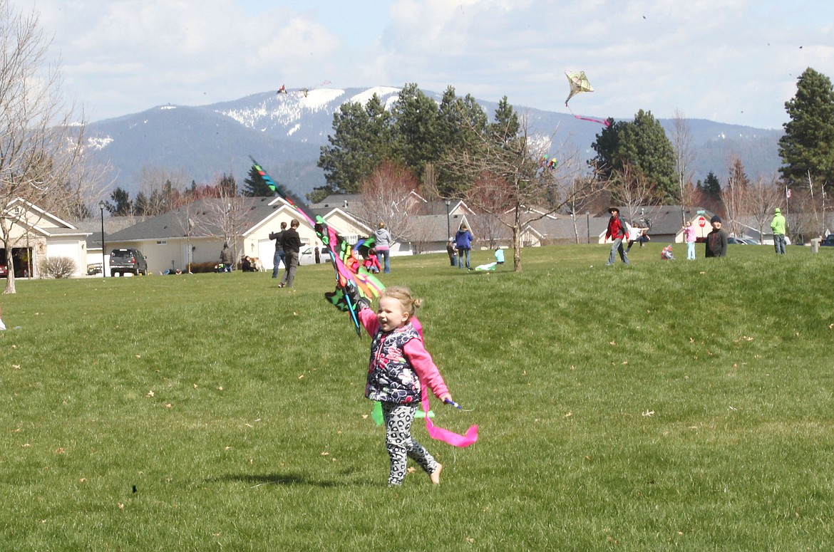 DEVIN WEEKS/Press
Elsie Peale, 4, of Hayden, joyfully scurries with her neon butterfly kite Saturday afternoon during the Hayden Kite Festival in Broadmoore Park. Hundreds of people came to the festival, where strong gusts of wind made it a perfect day to go fly a kite.