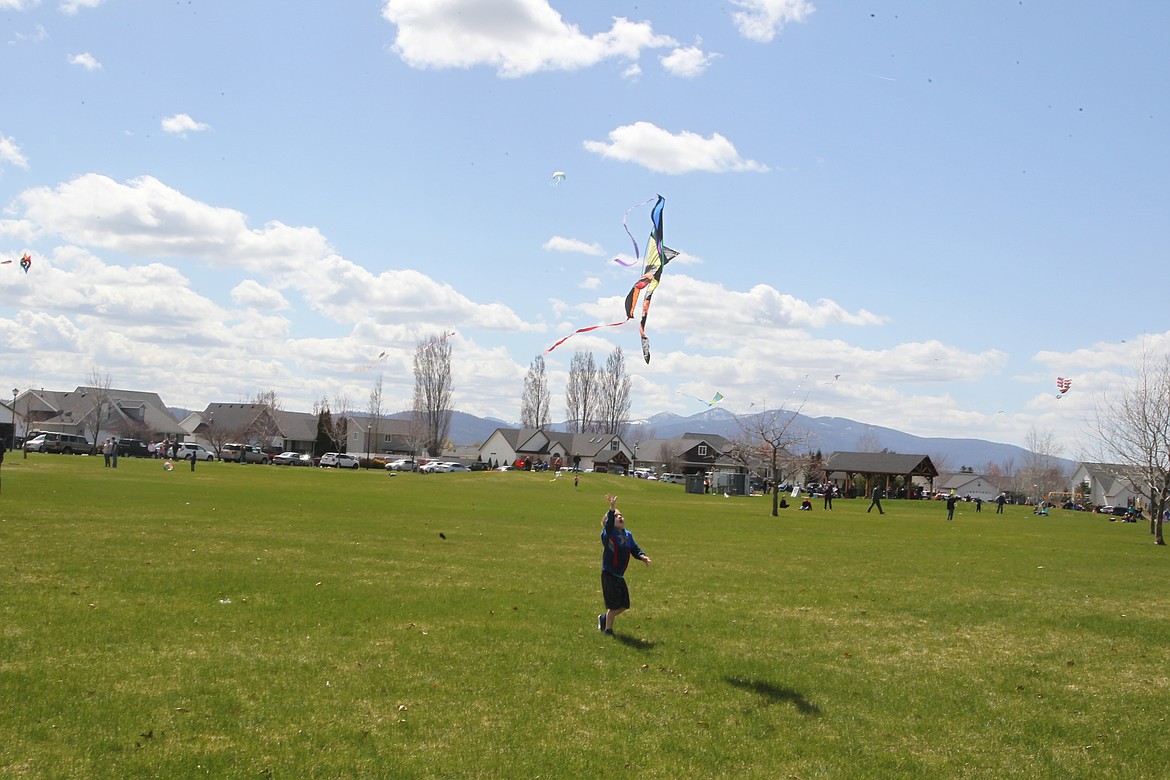 Greyson Bullen, 5, of Hayden, chases a kite flown by 7-year-old Tristan Cross (not pictured) during the Hayden Kite Festival in Broadmoore Park on Saturday. Festival participants competed for awards in categories including best kite crash, longest tail, highest flyer and best in show. (DEVIN WEEKS/Press)