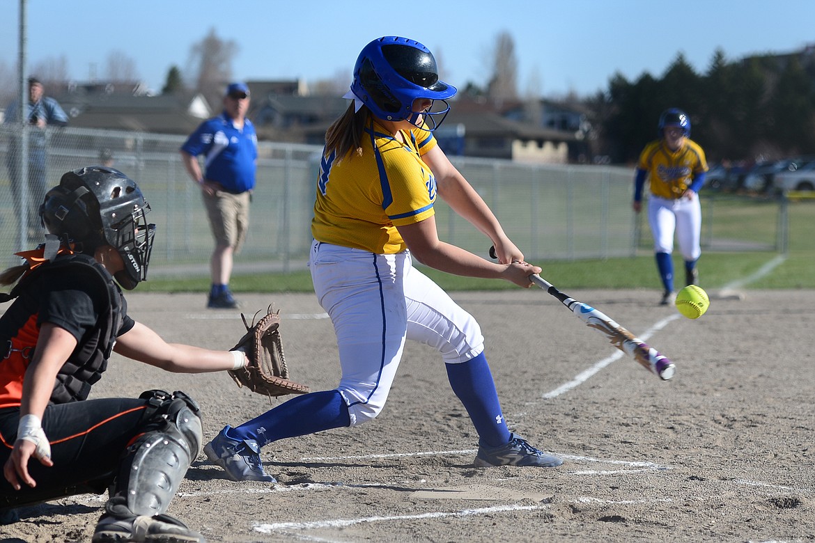 Libby's Emily Carvey connects on a two-run double in the first inning against Flathead on Tuesday. (Casey Kreider/Daily Inter Lake)