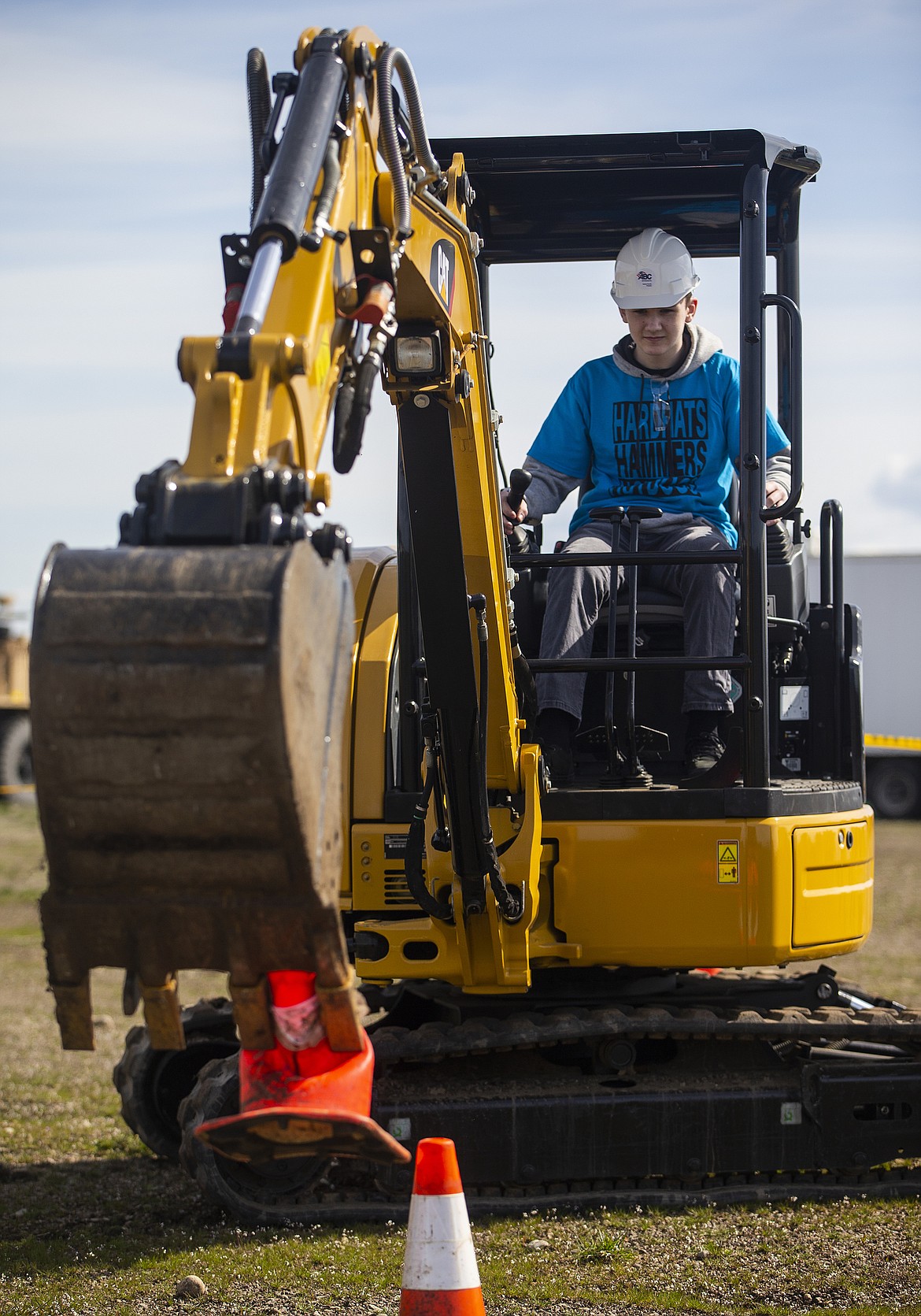 Coeur d&#146;Alene High freshman Brayden Cannon uses an excavator to pick up a cone.