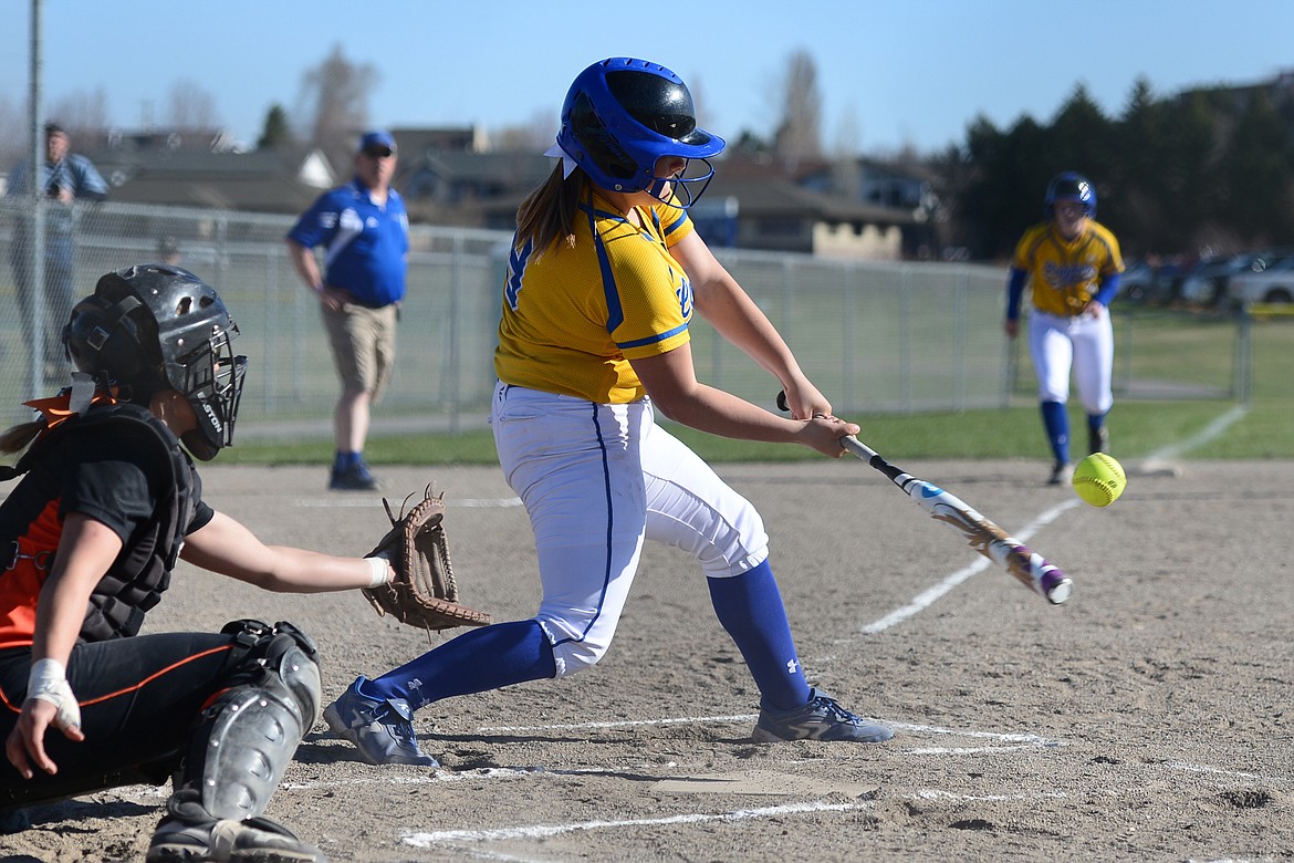 Libby&#146;s Emily Carvey connects on a two-run double in the first inning against Flathead on Tuesday. (Casey Kreider/Daily Inter Lake)
