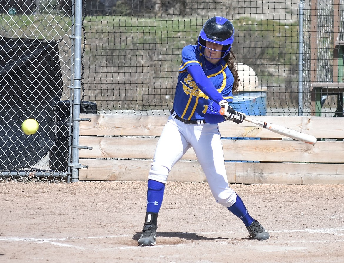 Libby junior Jayden Winslow hits a the ball right up the middle of the infield in a sacrificial play that got her tagged out at first, but let sophomore Ashlyn Monigold score in the bottom of the second inning against Ronan, April 20. (Ben Kibbey/The Western News)