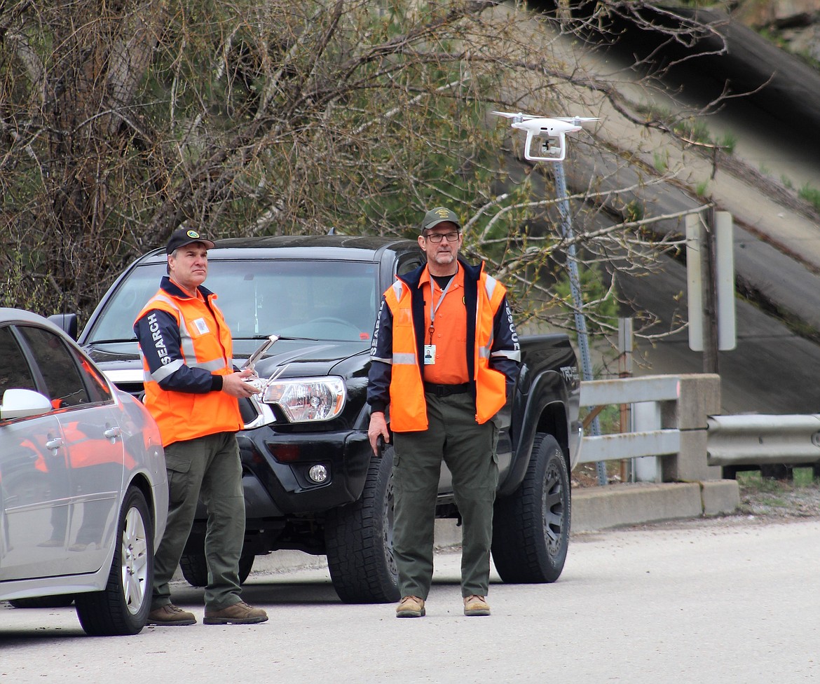 Crews launch a drone from the Elizabeth Park bridge to search the banks of the river.