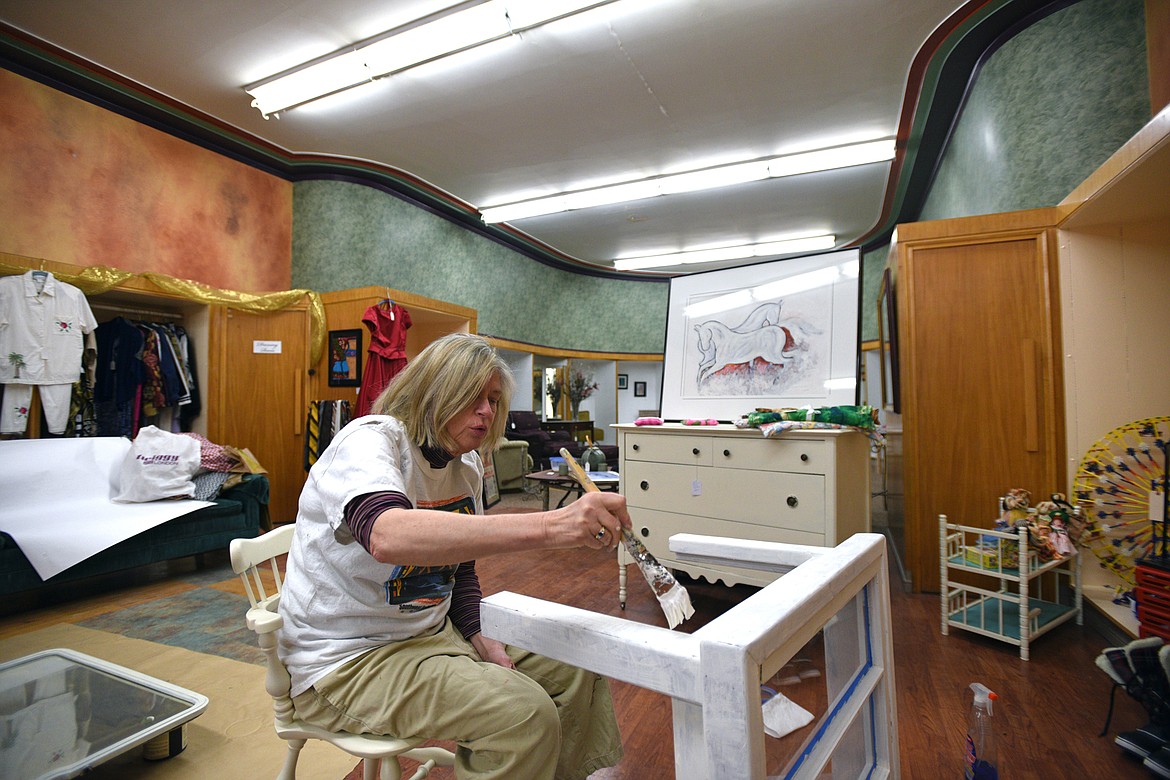 Lynn Bradley, of Kalispell, works on a coffee table at the pop-up shop Seasons in downtown Kalispell on Wednesday, April 11. (Casey Kreider/Daily Inter Lake)