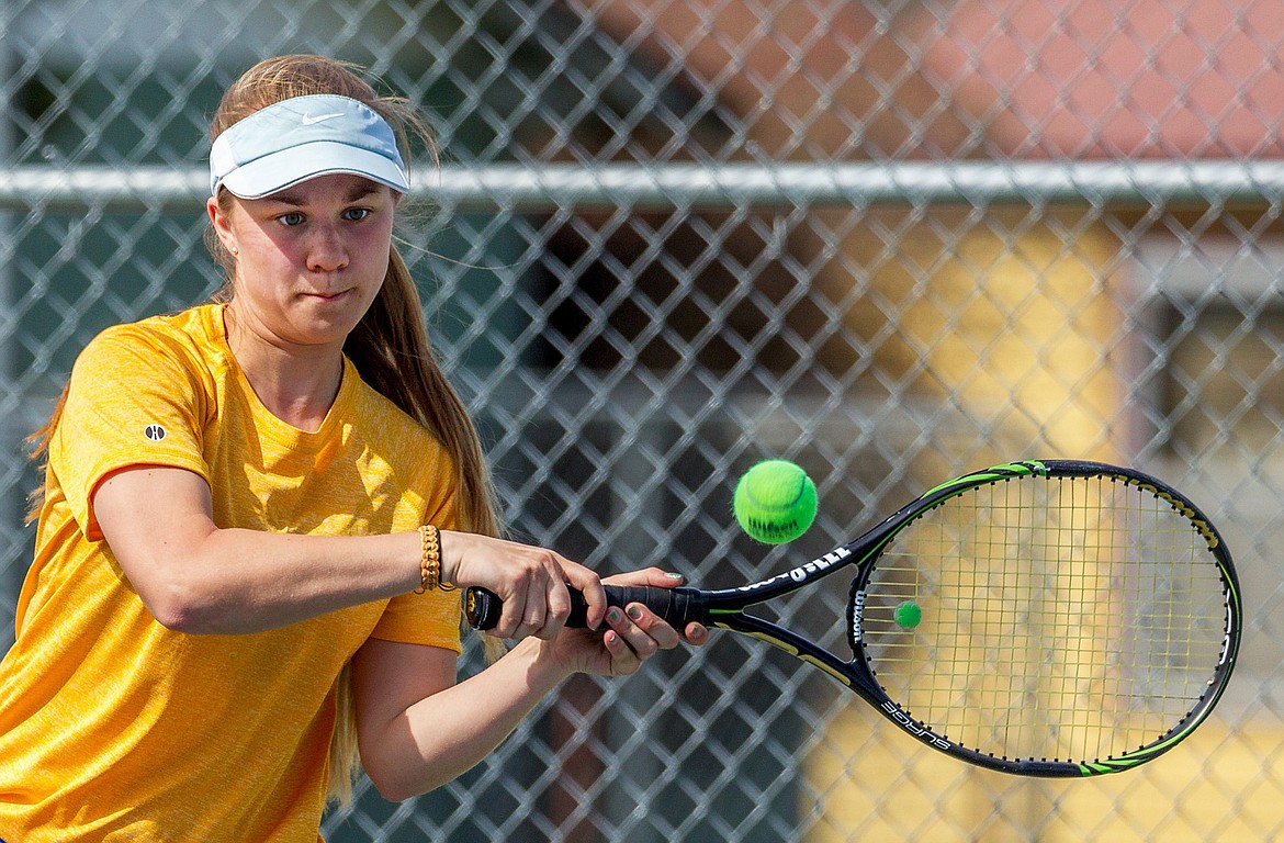 Libby’s Isabelle Martineau plays a singles match against Claire Carloss of Whitefish in Libby Friday. Carloss won in three sets, 2-6, 6-3, 6-1. (John Blodgett/The Western News)