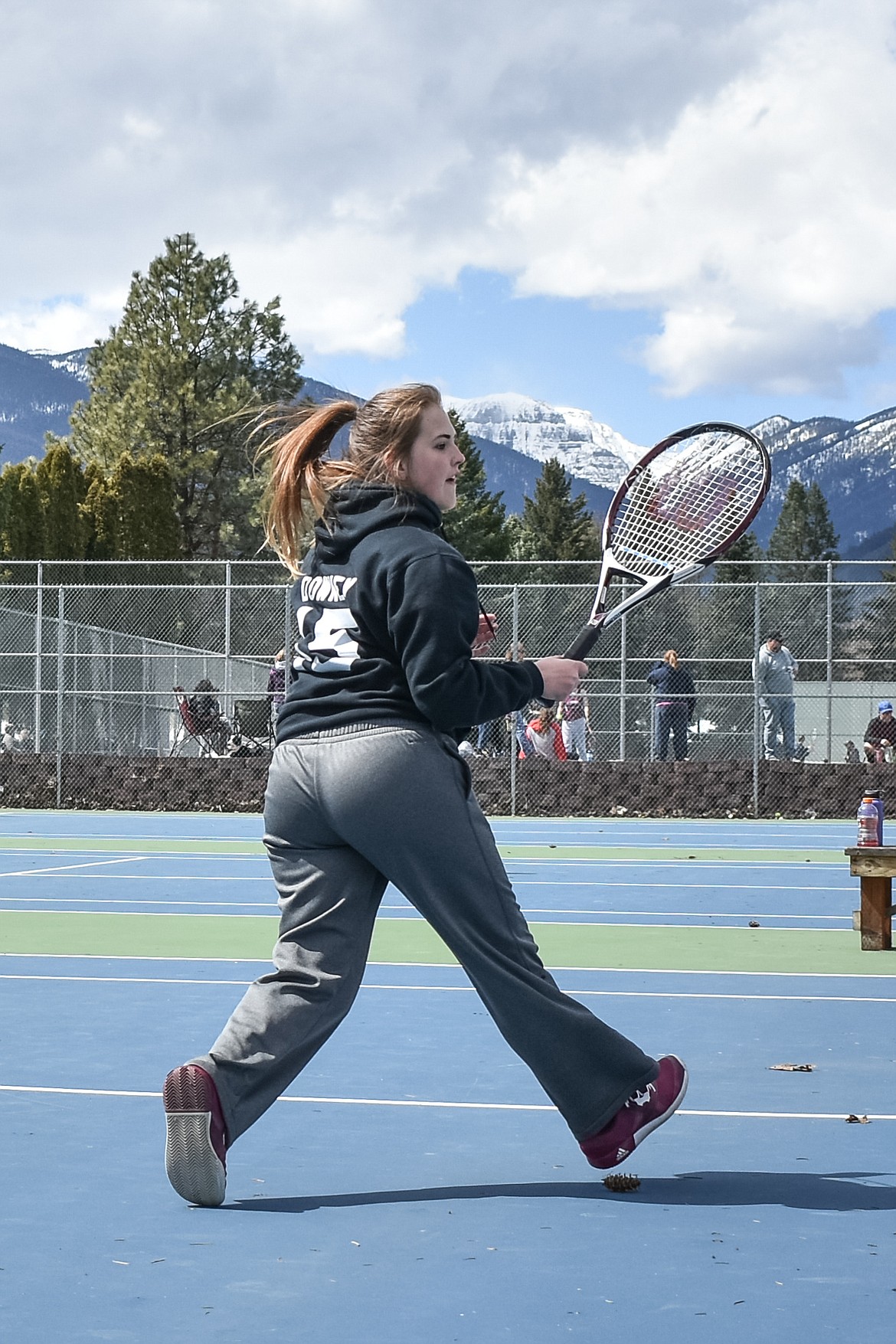 Troy&#146;s Kaitlyn Downey runs to the net while playing with her doubles partner Allie Coldwell, at the Libby Invitational, April 21. (Ben Kibbey/The Western News)