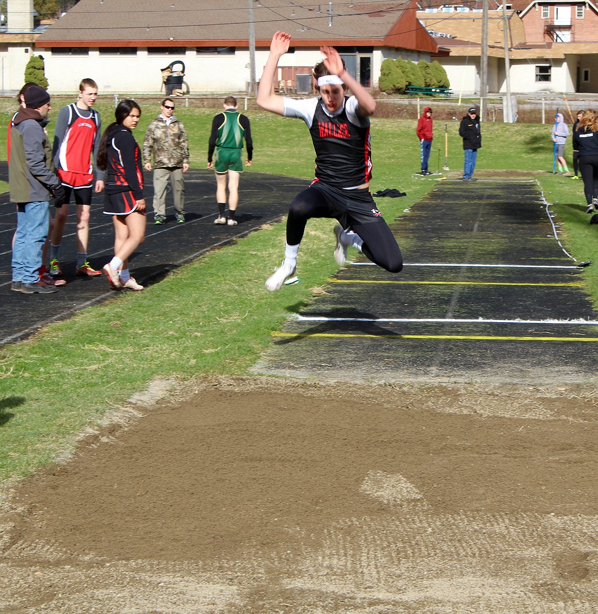 Photo by Chanse Watson 
Erik Brackebusch takes to the skies during his long jump at Sather Field.