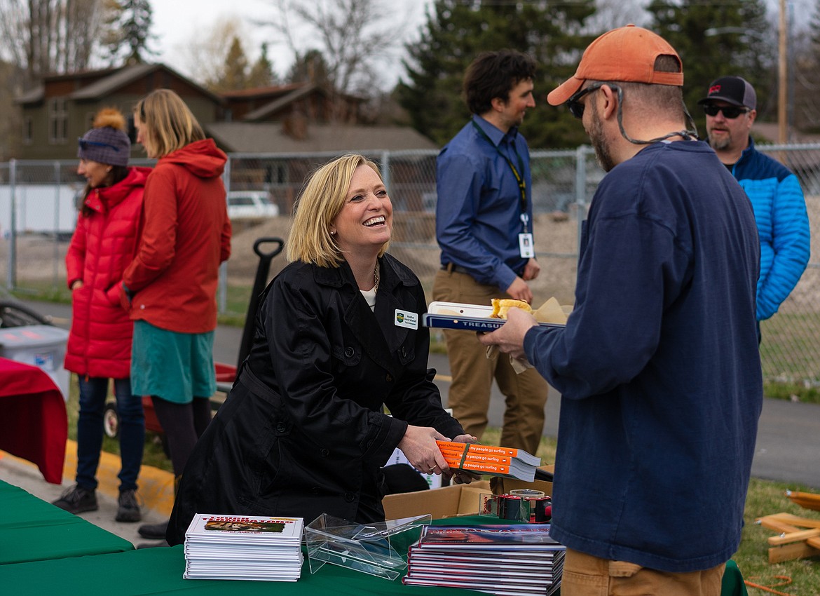 Whitefish School District Superintendent Heather Davis Schmidt chats with a visitor during Earth Day celebrations Saturday afternoon.