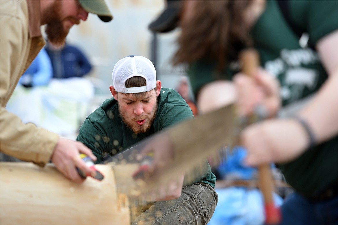 Flathead Valley Community College&#146;s Kylor Yohn, center, and Darian Enders, right, compete in the Jack and Jill Double Buck event during Stumpjumper Days at the FVCC Logger Sports Arena on Saturday. At top left is fellow teammate Jim Vincent. (Casey Kreider/Daily Inter Lake)