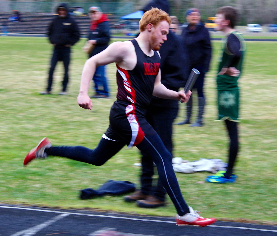 Jaden Dimitroff carries the baton across the finish line at Wallace&#146;s recent home track meet. 

Photo by Chanse Watson