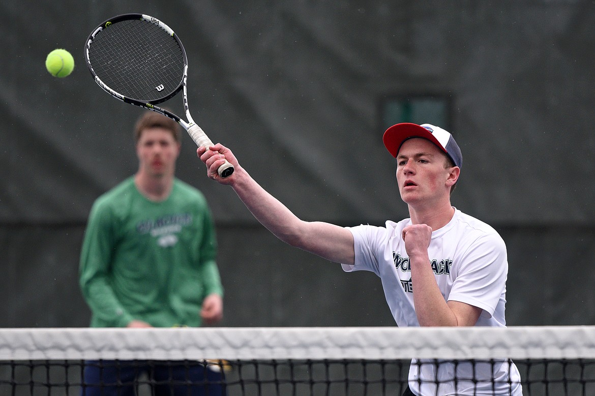 Glacier High School's Morgan Cordell returns a ball at the net against Missoula Hellgate's doubles team of River Duce and Cole Tolleson-Knee at Flathead Valley Community College on Saturday. In the background is Cordell's doubles teammate Drew Engellant. (Casey Kreider/Daily Inter Lake)