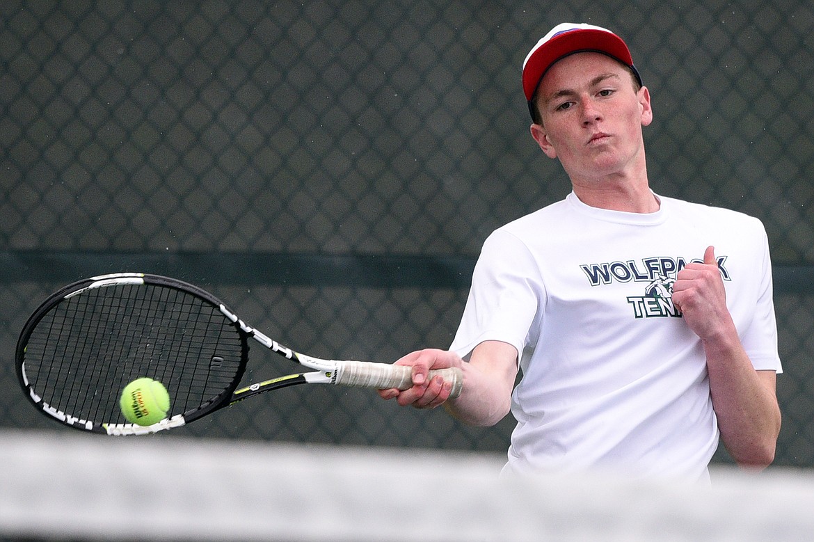 Glacier High School's Morgan Cordell hits a return against Missoula Hellgate's doubles team of River Duce and Cole Tolleson-Knee at Flathead Valley Community College on Saturday. Cordell's doubles teammate was Drew Engellant. (Casey Kreider/Daily Inter Lake)