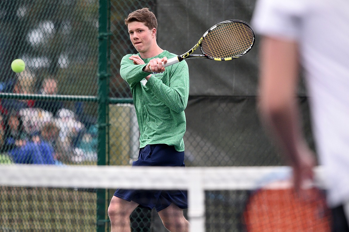 Glacier High School's Drew Engellant hits a return against Missoula Hellgate's doubles team of River Duce and Cole Tolleson-Knee at Flathead Valley Community College on Saturday. Engellant's doubles teammate was Morgan Cordell. (Casey Kreider/Daily Inter Lake)