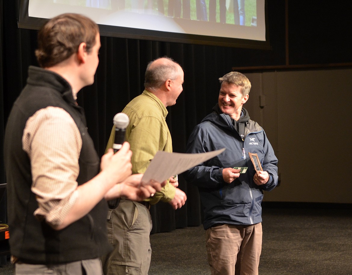 Doug Reed, far right, accepts one of the business Climate Smart Champion awards from Steve Thompson while Climate Smart Glacier Country vice chairman Matt Folz talks about Whitefish Lake Restaurant.  The awards were presented Saturday during the Earth Day celebration at Whitefish High School.  (Heidi Desch/Whitefish Pilot)