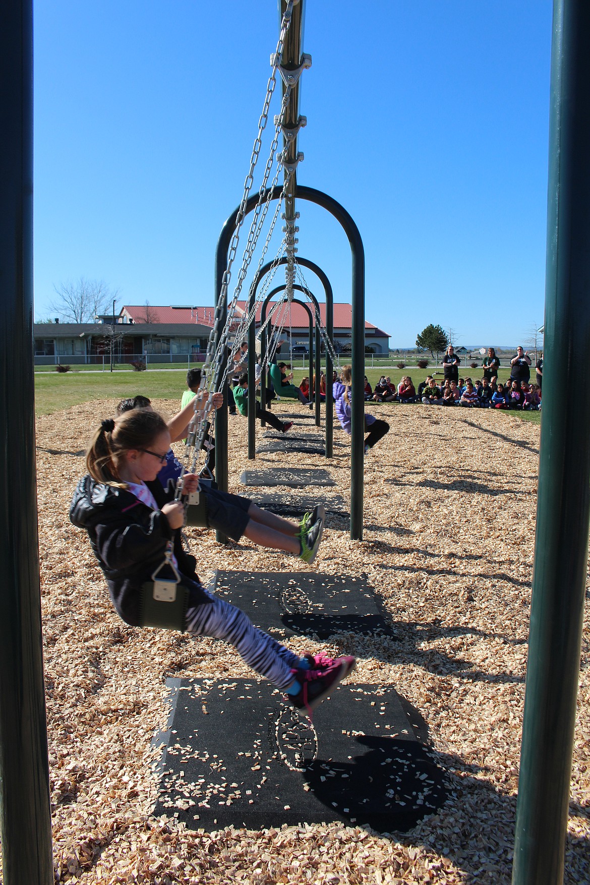 Cheryl Schweizer/Columbia Basin Herald
Some lucky kids got to try out the brand-new swings at Park Orchard during the dedication ceremony Thursday.