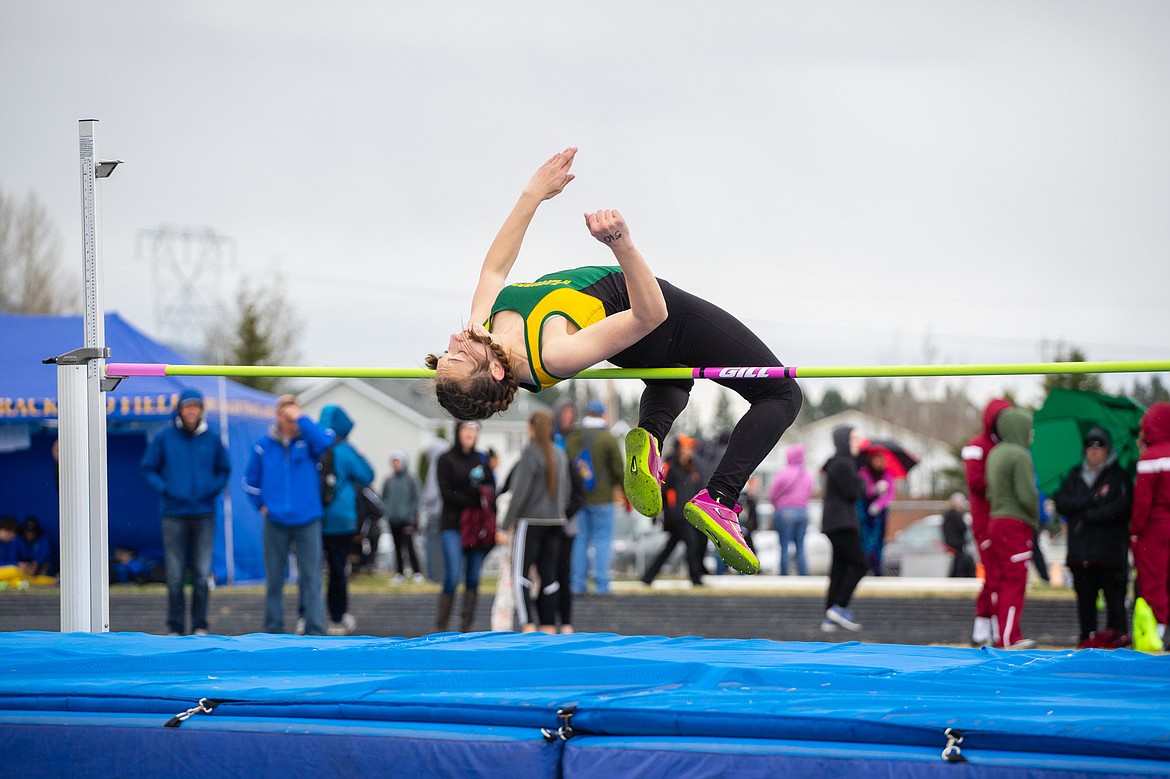 Alice Wilde leaps over the bar in the high jump Saturday morning in Columbia Falls.