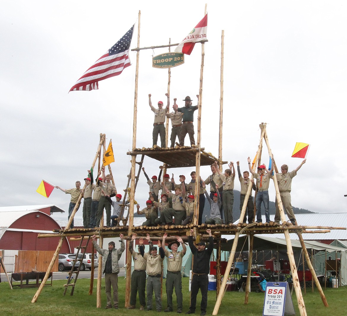 DEVIN WEEKS/Press
The Boy Scouts of Coeur d&#146;Alene Troop 201 are triumphant Saturday as they raise their arms arms into the air while on top of the extreme campsite gateway they built for this year&#146;s Scout-O-Rama