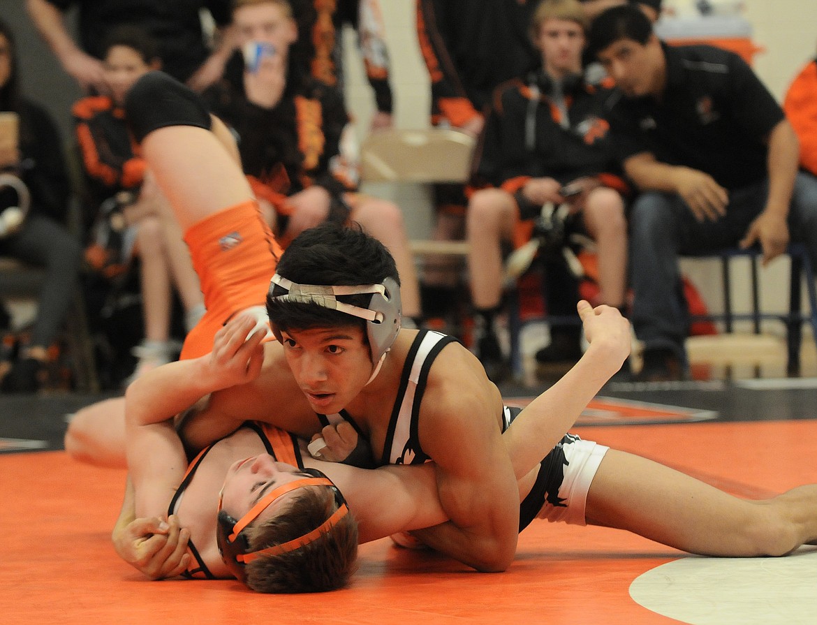 Flathead&#146;s Trae Vasquez looks to the ref to call the first-period pin of Eureka&#146;s during a dual at Kalispell Middle School on Saturday. The Braves defeated the Lions 40-28. (Aaric Bryan/Daily Inter Lake)