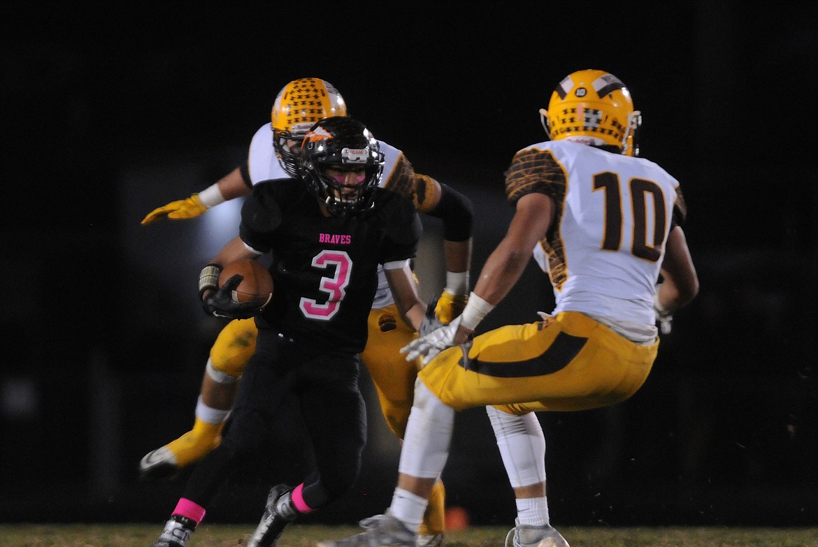 Flathead&#146;s Trae Vasquez jukes Capital&#146;s Marcus Welnel on a punt return in the second quarter at Legends Stadium Friday. (Aaric Bryan/Daily Inter Lake)