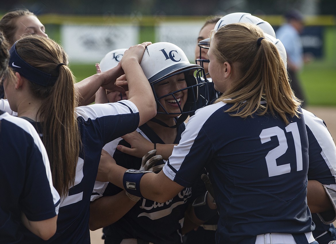 Lake City teammates greet Ashlynn Allen at home plate after she hit a home run against Lewiston in the 5A Region 1 tournament championship game Tuesday at Lake City.

LOREN BENOIT/Press