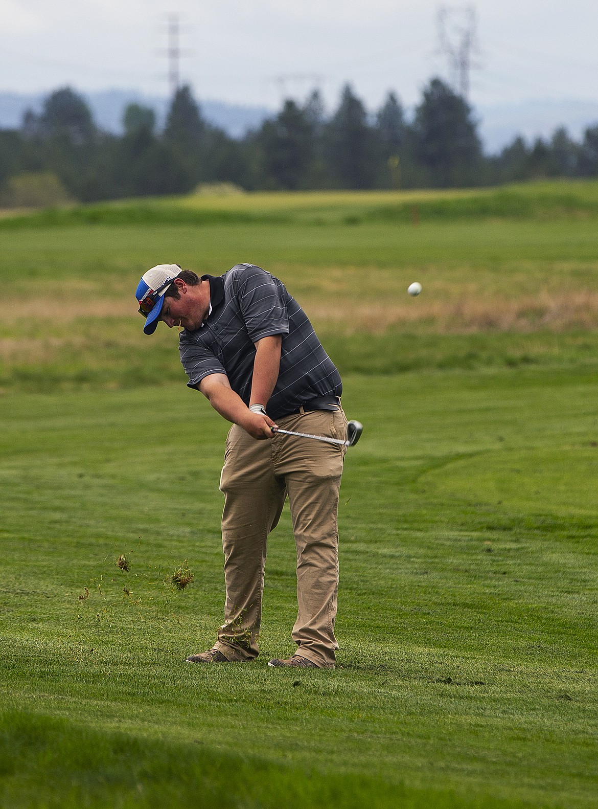 LOREN BENOIT/Press
Kadin Olson of St Maries hits an iron shot Monday morning at the 2A District 1 tournament at The Links Golf Club.